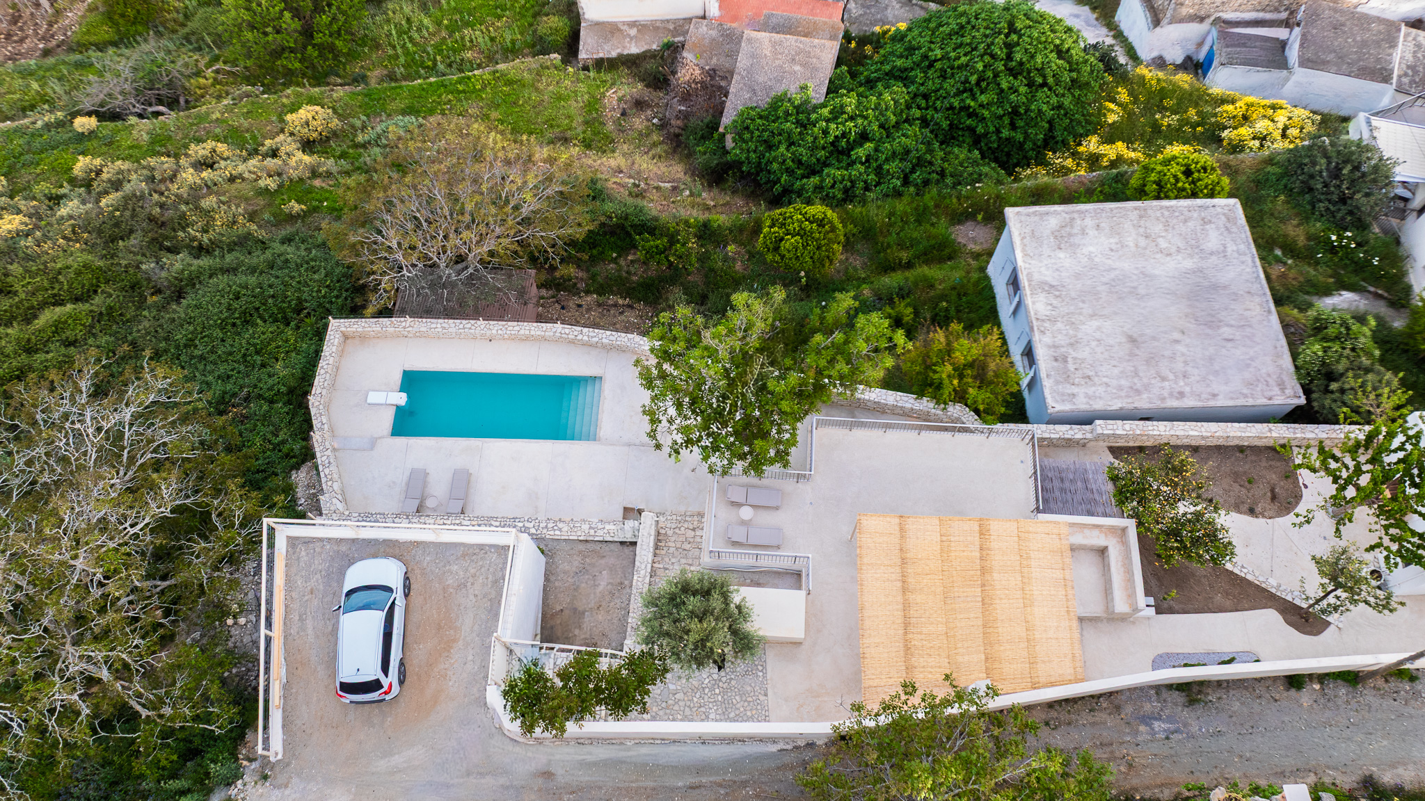 Aerial view showing road, parking, garden, terrace, house, and pool at Nogal Retreat